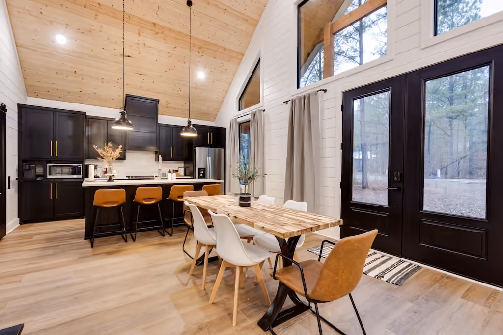 A modern wood-paneled kitchen and dining room